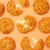 Pumpkin Spiced New York Cookie by Crumbs & Doilies with white chocolate chunks and warm autumn spices.